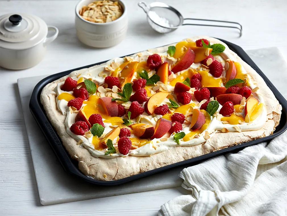 Pavlova con almendras, frambuesas y melocotón